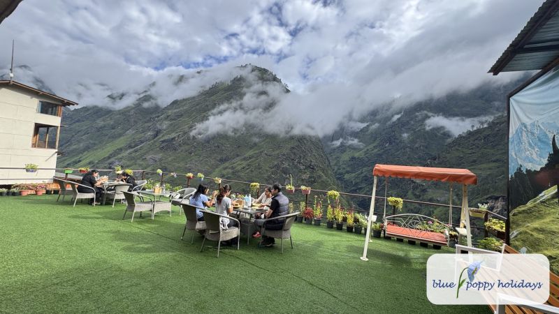 Guests on the lawn terrace at Blue Poppy Premier, Joshimath